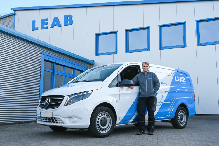 Service technician in front of his mobile workshop